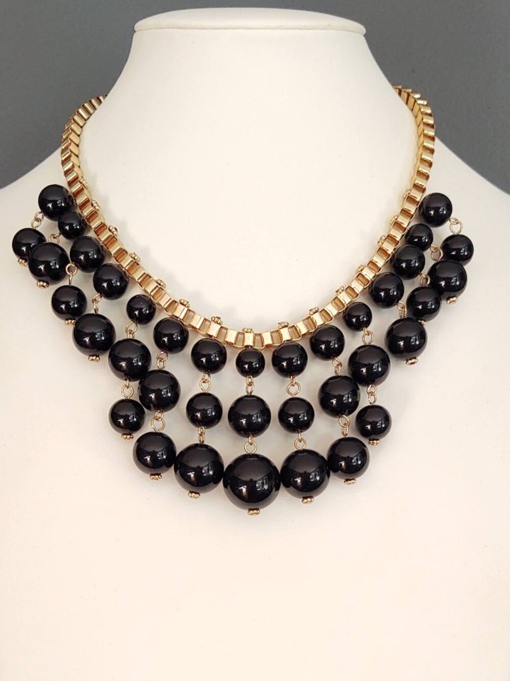 Black hanging baubles on gold box chain necklace